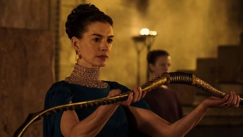 Penelope holding Odysseus' bow in The Odyssey