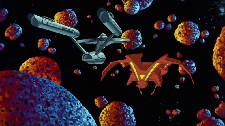 The U.S.S. Enterprise facing off against an Orion ship in an asterpoid field in Star Trek: The Animated Series