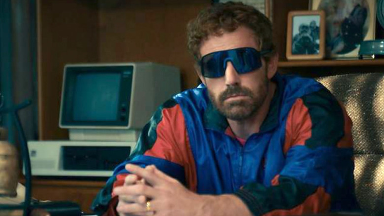 Air - Phil Knight sitting at his desk in tracksuit and sunglasses