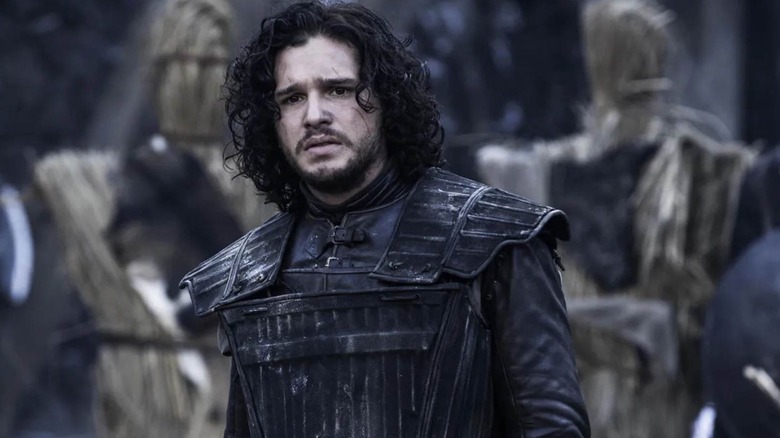 Jon Snow (Kit Harington) stands forlornly in a court in Game of Thrones