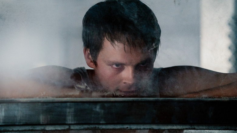 Thale (Sam Strike) peers out of a steaming pod in Nightflyers (2018)