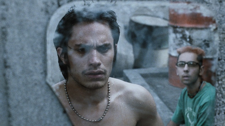 Gael García Bernal looks in mirror in Amores Perros