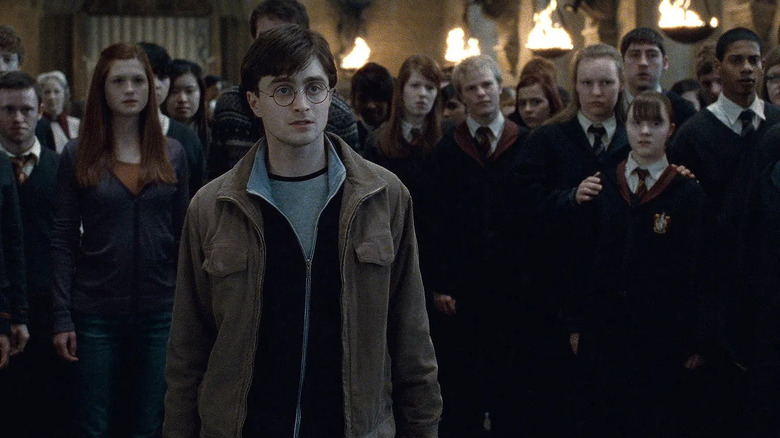 Harry standing in front of a group of students in the Great Hall in Harry Potter and the Deathly Hallows — Part 2