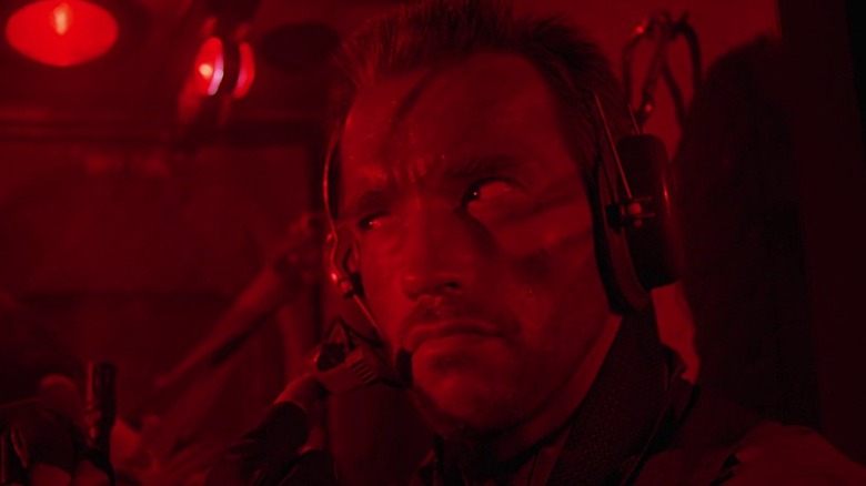 Dutch (Arnold Schwarzenegger) basked in red light in a helicopter in Predator