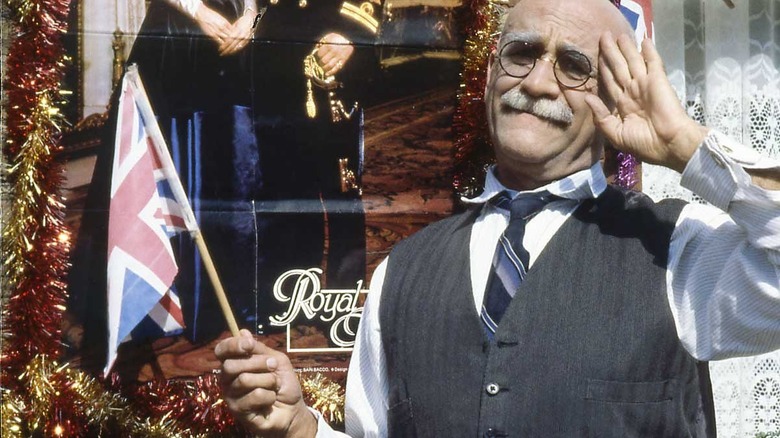 Warren Mitchell as Alf Garnett saluting the Union Jack in In Sickness and in Health