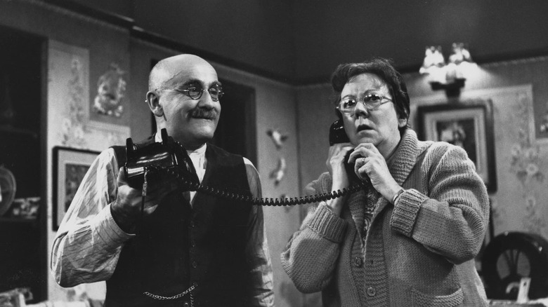 Alf and Else Garnett holding a phone in Till Death Do Us Part
