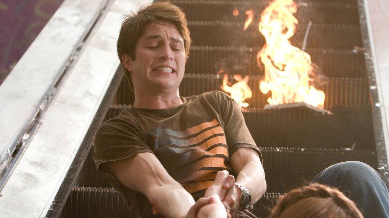 Bobby Campo as Nick pulling Shantel VanSanten as Lori up the escalator in The Final Destination