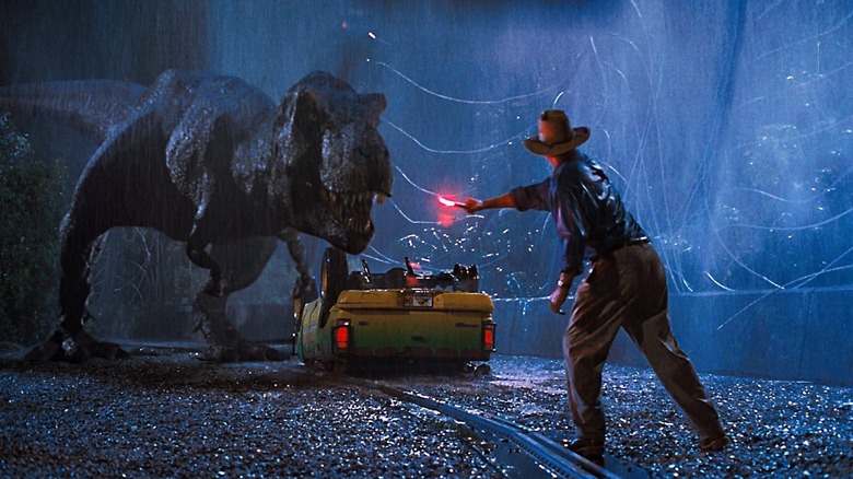 Sam Neill's Alan Grant waving a flare at the T-rex in Jurassic Park