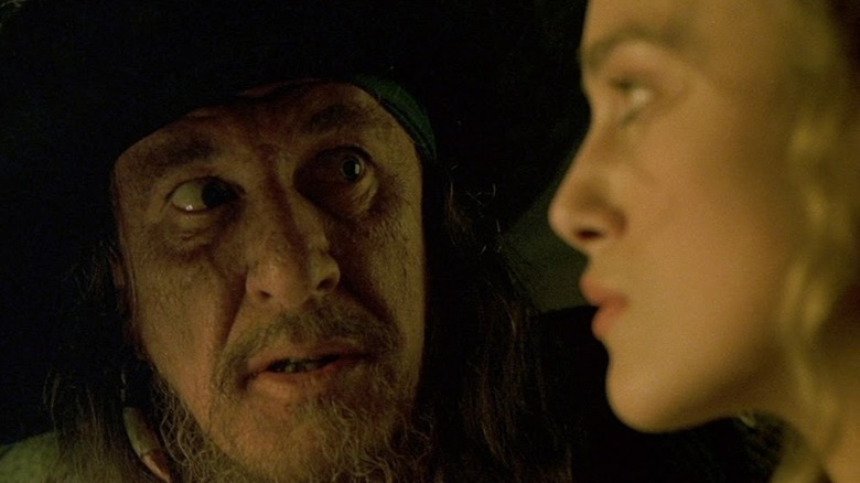 Geoffrey Rush as Barbosa staring intensely at Keira Knightley as Elizabeth Swan in Pirates of the Caribbean: The Curse of the Black Pearl