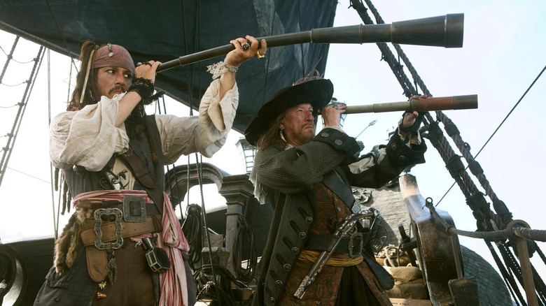 Johnny Depp as Jack Sparrow and Geoffrey Rush as Barbosa looking through spyglasses in Pirates of the Caribbean: At World's End