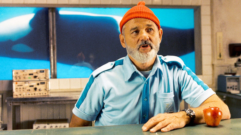 Steve Zissou sits in front of a whale