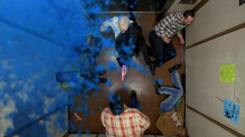 The Dean shooting an attacker in the elevator, leaving a paint stain on the camera, in Community