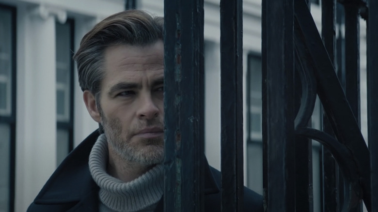 Chris Pine peering behind a fence