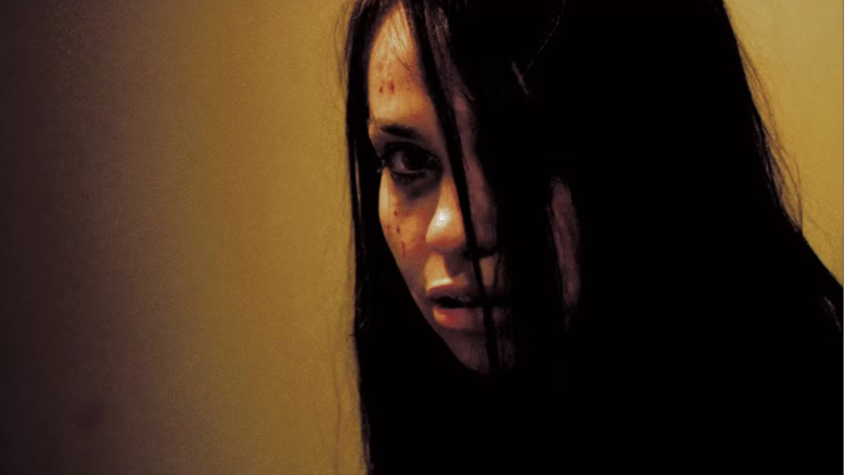 Bloody woman hiding from a woman