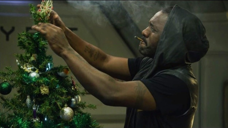 Idris Elba decorating a Christmas tree