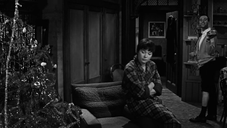 Woman looking near Christmas tree