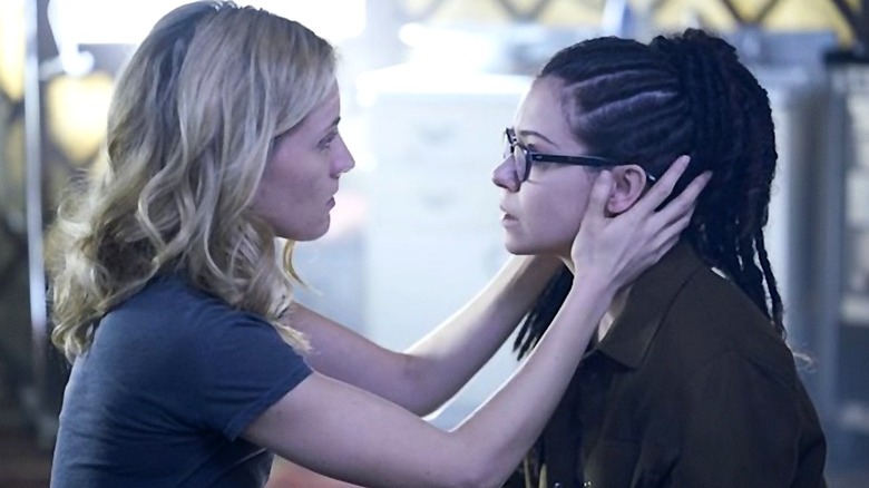 Delphine holds Cosima's face