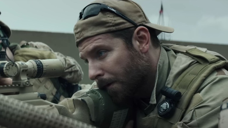 Bradley Cooper as Chris Kyle aiming a rifle in American Sniper