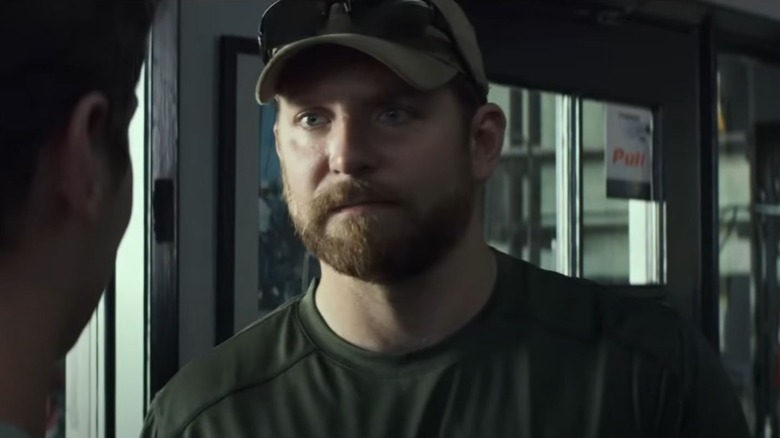 Bradley Cooper as Chris Kyle wearing a baseball cap in American Sniper