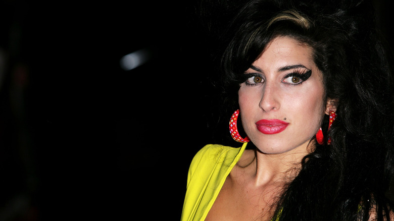 Amy Winehouse with a dark background