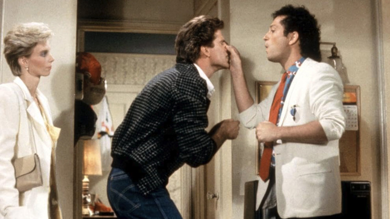Howie Mandel as Dennis Powell holds the nose of Ted Danson as Spence Holden in A Fine Mess