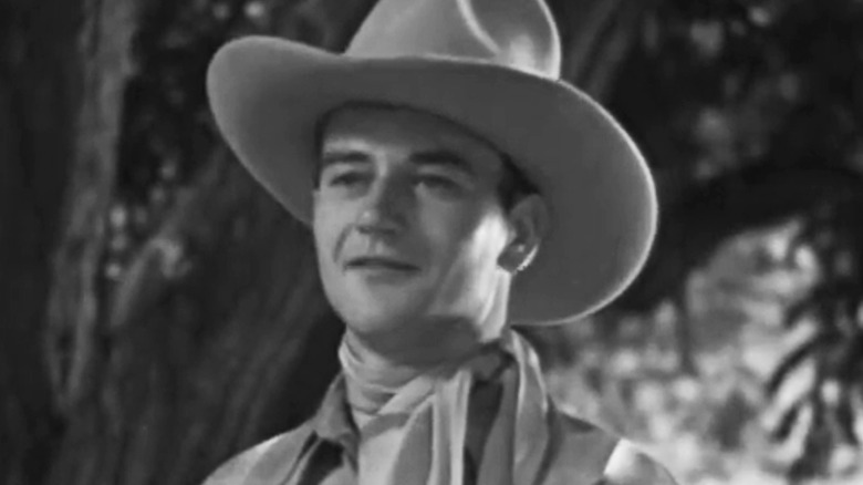 John Wayne's John Drury smiles rides her, cowboy
