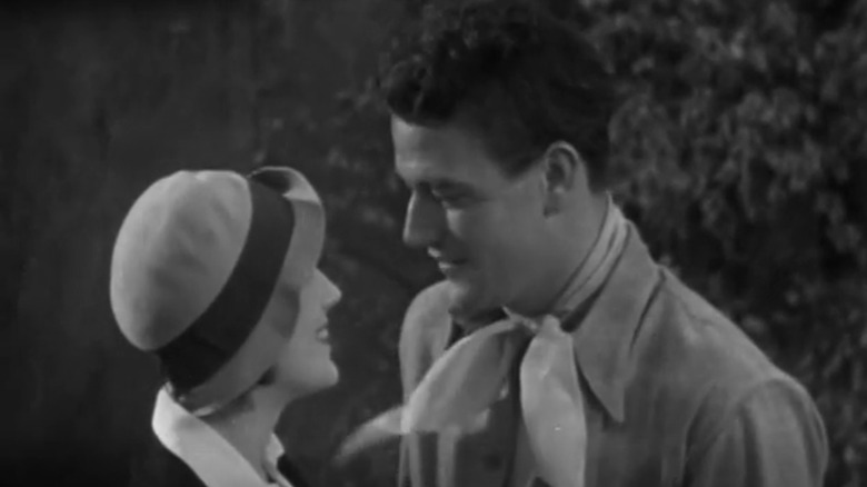 John Wayne's John Drury standing Ruth Hall's Ruth Gaunt opposite he rides he cowboy