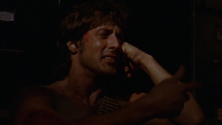 Sylvester Stallone's John Rambo cries as he sits in shadow in First Blood.jpg