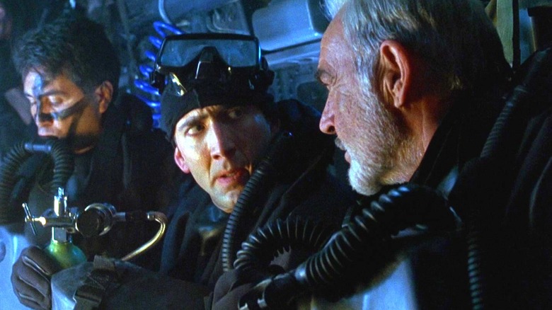 Sean Connery's John Patrick Mason sits beside Nicolas Cage's Dr Stanley Goodspeed in a helicopter in The Rock