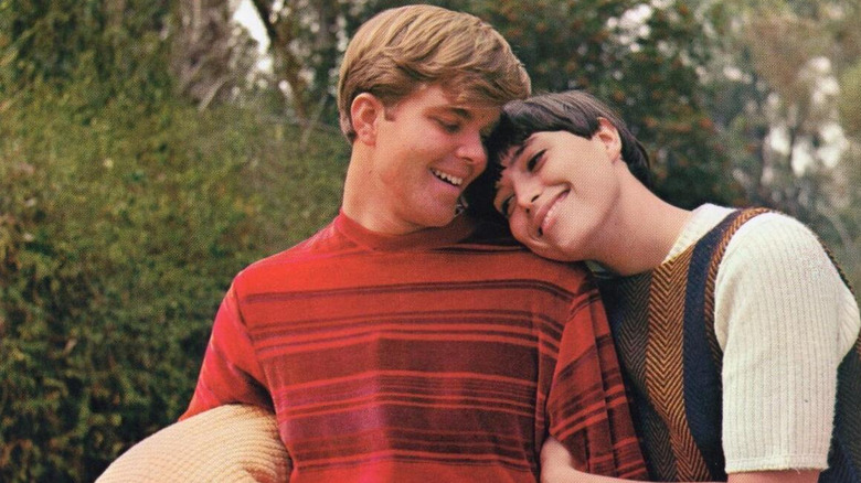 Two characters from Young Americans, arm in arm