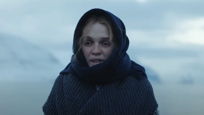 Odssa Young as Eva stands in a snowy environment in the lane