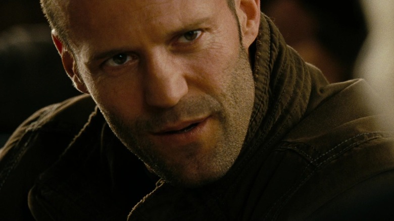 Jason Statham as Arthur Bishop listening intently in The Mechanic