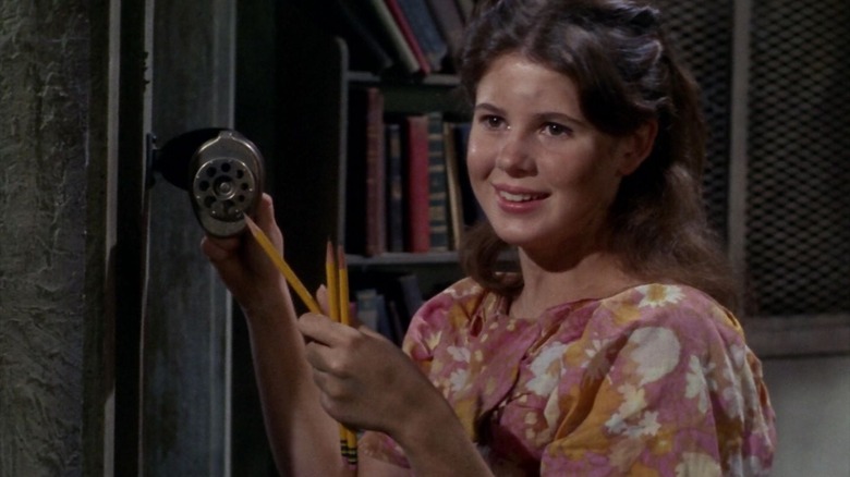 Miri sharpening pencils in an abandoned classroom on Star Trek