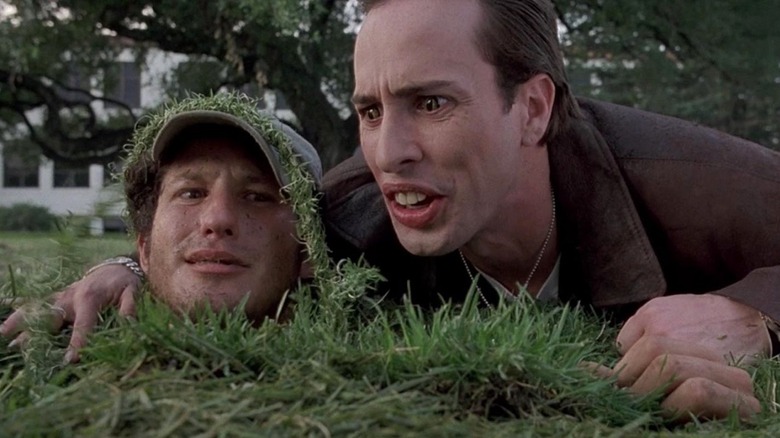 Alexis Arquette as Tony Reno torments a victim buried in grass in Sometimes They Come Back... Again