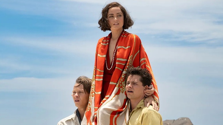 Ana de Armas as Eloise Bosquet de Wagner Wehrhorn is held aloft by boy toys Toby Wallace as Robert Phillipson and Felix Kammerer as Rudolph Lorenz in Eden