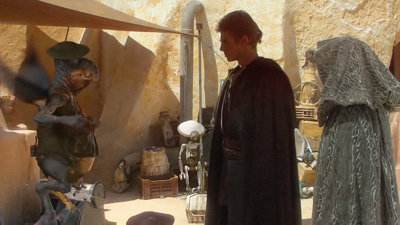 Anakin Skywalker (Hayden Christensen) speaks with Watto in Star Wars: Episode II — Attack of the Clones