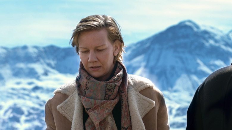 Sandra Hüller as Sandra Voyter standing in front of snowy mountains in Anatomy of a Fall