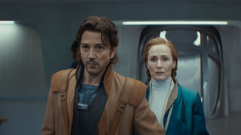Diego Luna as Cassian Andor protecting Genevieve O'Reilly as Mon Mothma in the Andor season 2 episode Welcome to the Rebellion