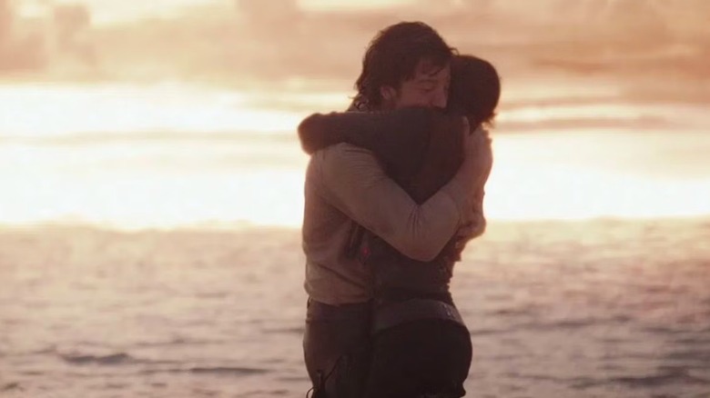 Jyn Erso and Cassian Andor holding each other as the Death Star blasts Scarif in Rogue One