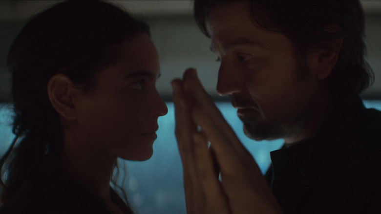 Cassian and Bix touch hands in a moving yet tragic way in Andor