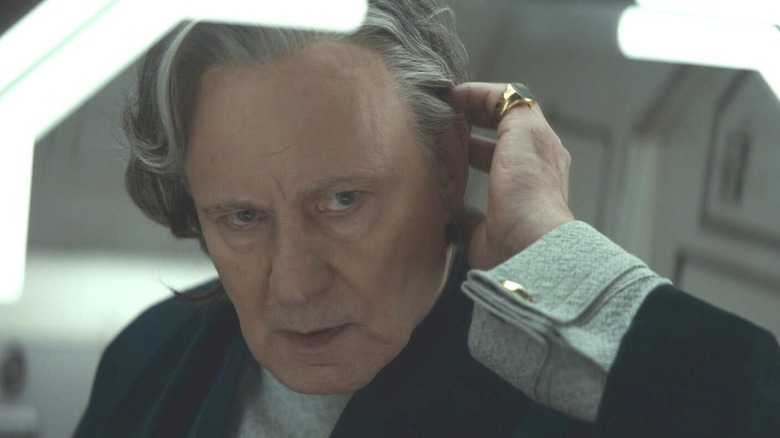 Luthen checking his wig in the mirror in Andor season 2