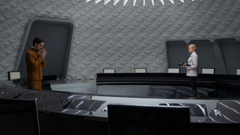 Kyle Soller as Syril Karn and Denise Gough as Dedra Meero in an Imperial meeting room in Andor season 2