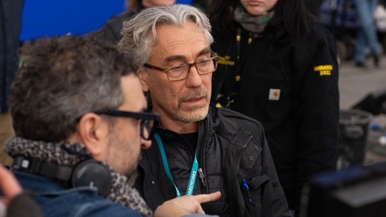 A behind the scenes image of Tony Gilroy surrounded by his collaborators on the Andor set