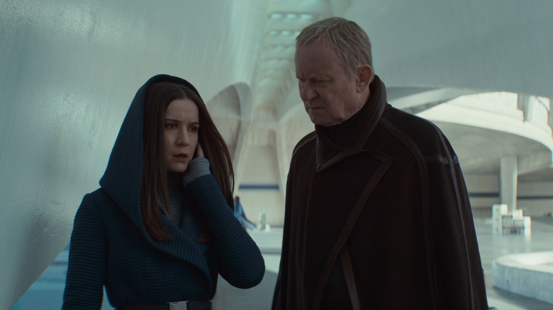Kleya gets a message on her earpiece as Luthen stands next to her in Andor season 2