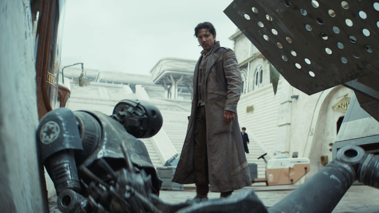 Cassian Andor stands over a broken K-2SO droid in Andor season 2