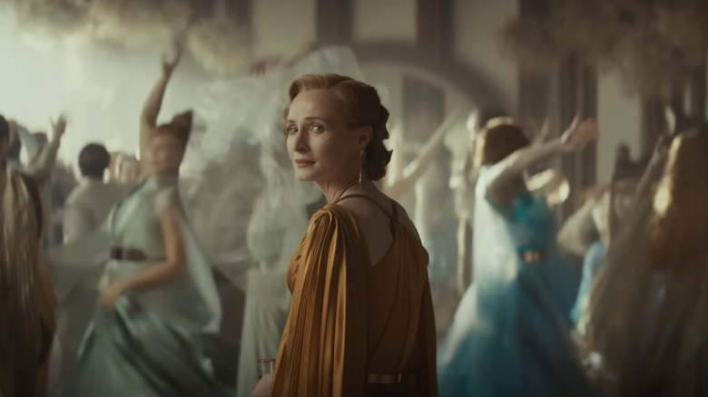 Genevieve O'Reilly as Mon Mothma looking forlornly over her shoulder in front of dancers in Andor season 2