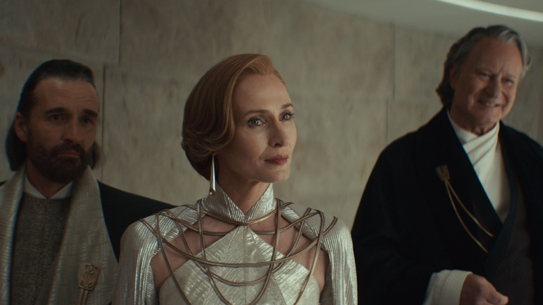 Genevieve O'Reilly as Mon Mothma, Alastair Mackenzie as Perrin Fartha, and Stellan Skarsgård as Luthen Rael gathered at a party in Andor season 2
