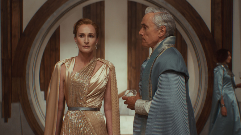 Genevieve O'Reilly as Mon Mothma speaking in secret with Ben Miles as Tay Kolma at a party in Andor season 2