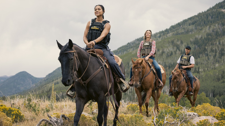 Ash Santos' Andrea Cruz, Arielle Kebbel's Belle Skinner, and Tatanka Means' Miles Kittle ride one behind the other on horses in Marshals.jpg