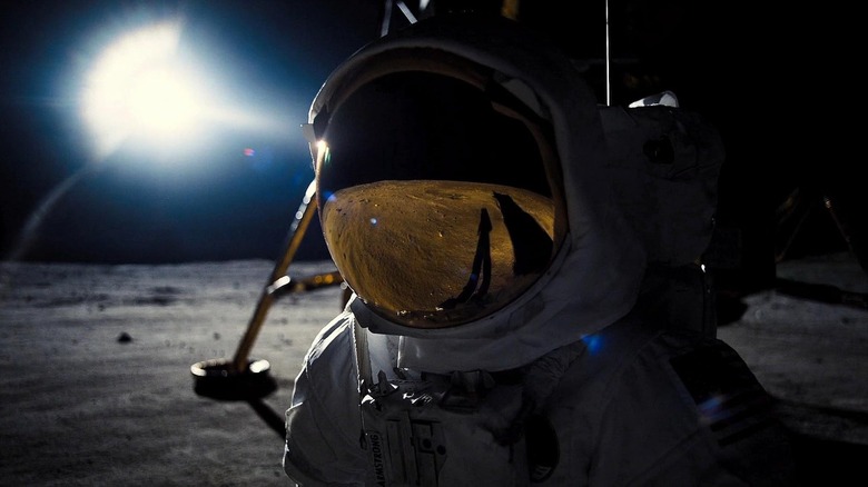 Ryan Gosling as Neil Armstrong wearing a spacesuit on the Moon in First Man